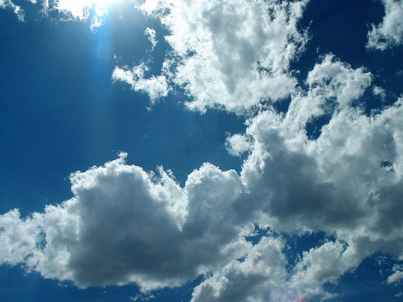 a plane is flying in the sky with lots of clouds