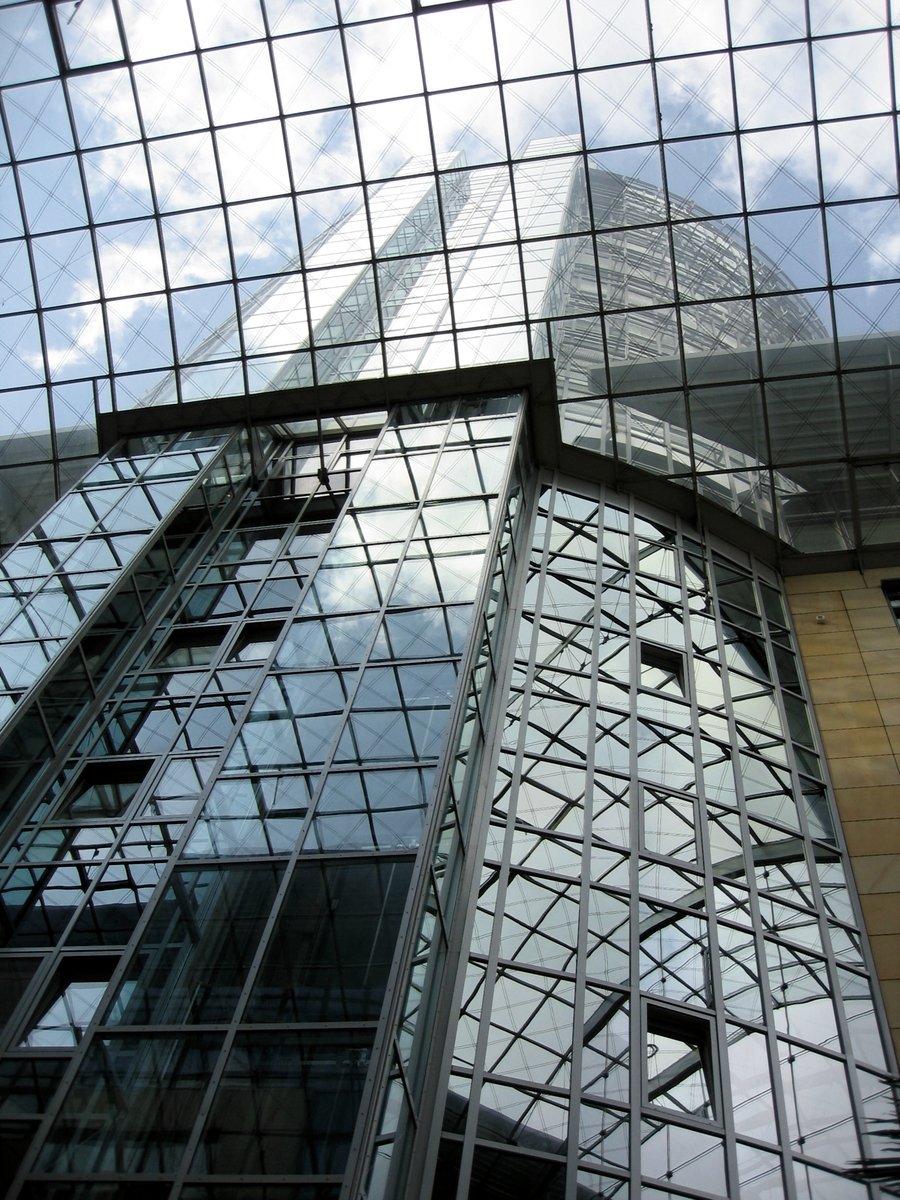 modern glass buildings against the sky, as seen from below