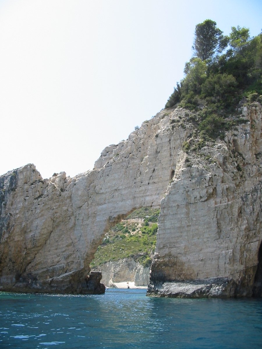 an image of an ocean entrance going into the rocks