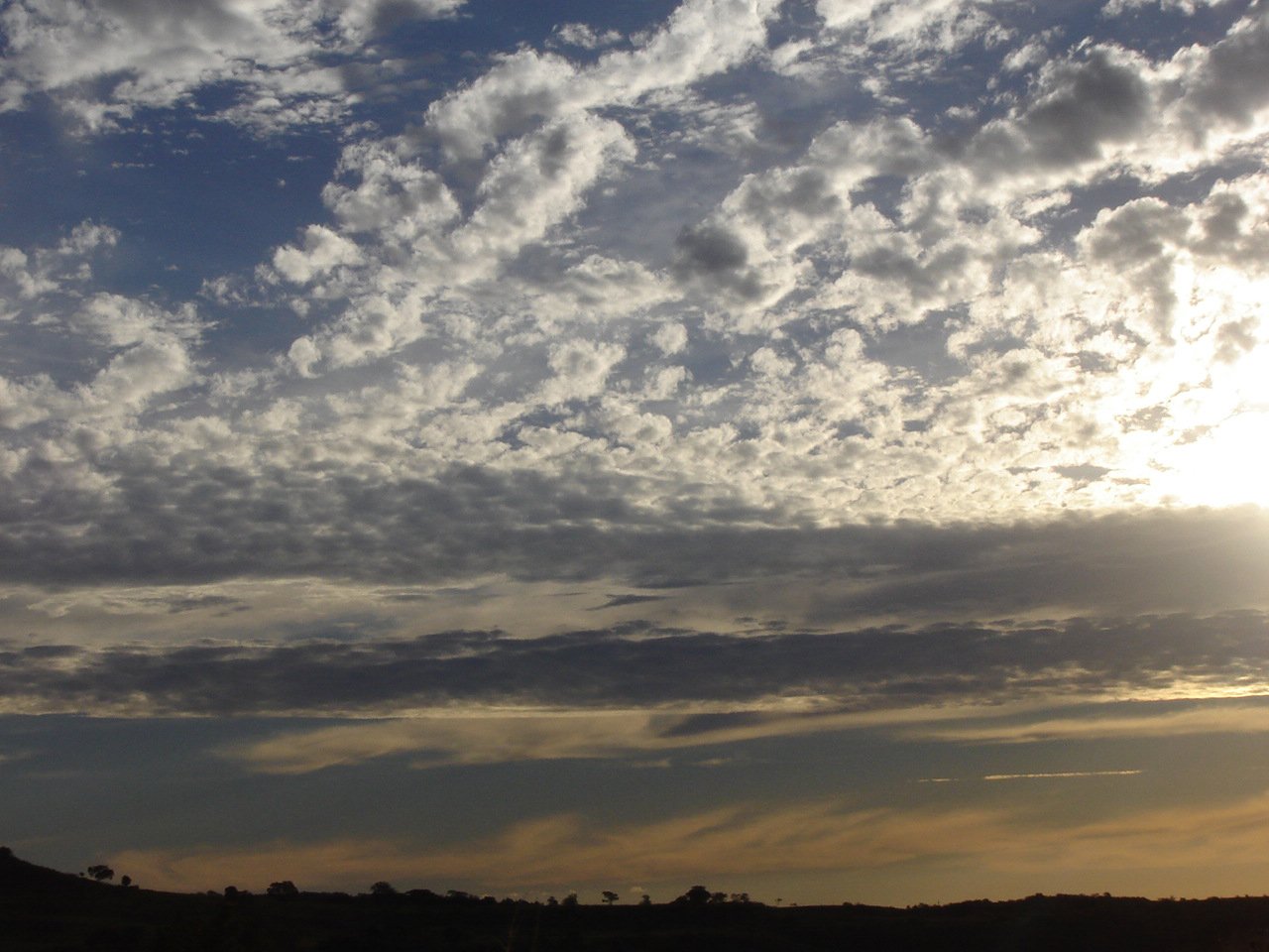 several clouds are floating high in the sky