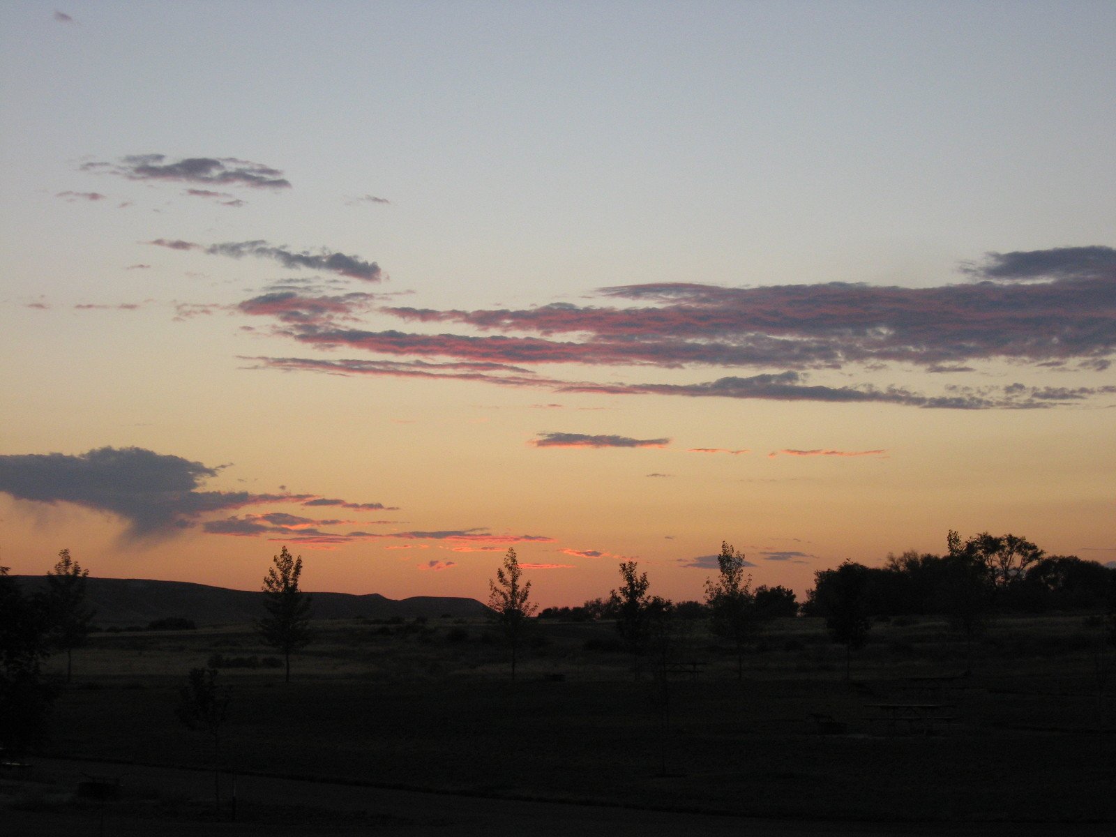 the sunset is over the desert on the horizon