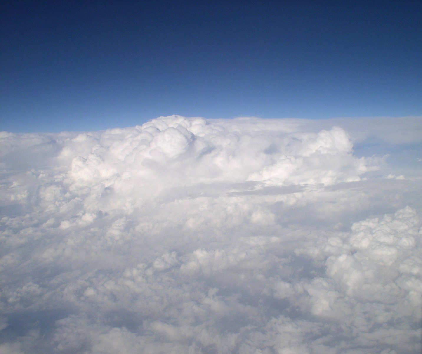 an aerial s of clouds and a blue sky