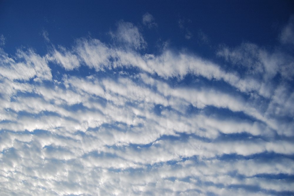 some clouds that are in the blue sky