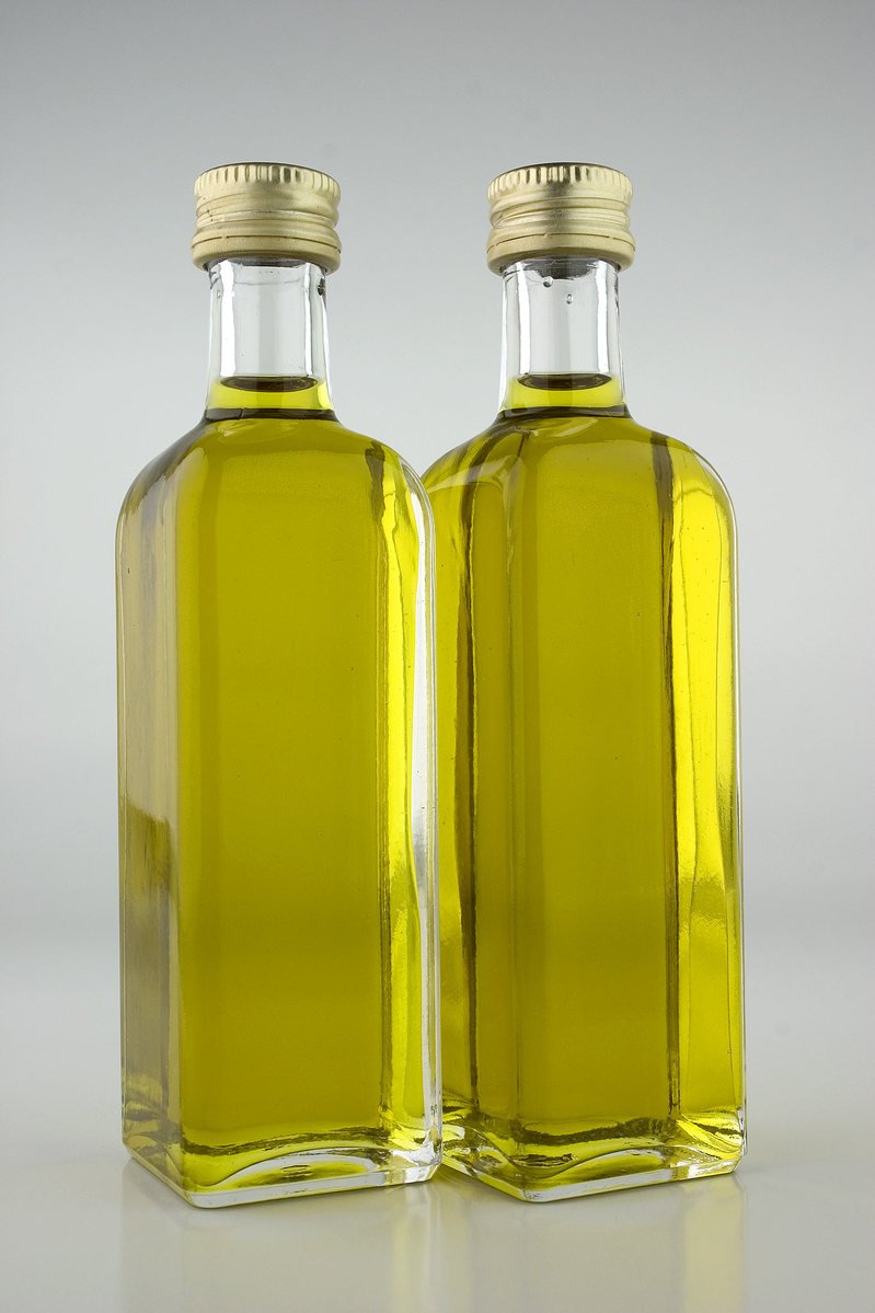 two empty yellow glass bottles on a table