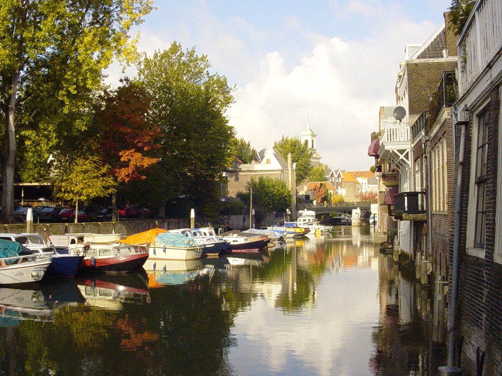 a river that has many small boats in it