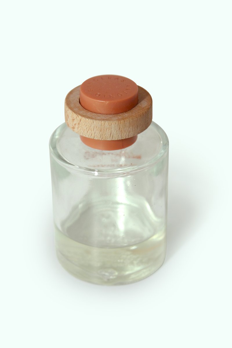 the small jar is holding a wooden lid