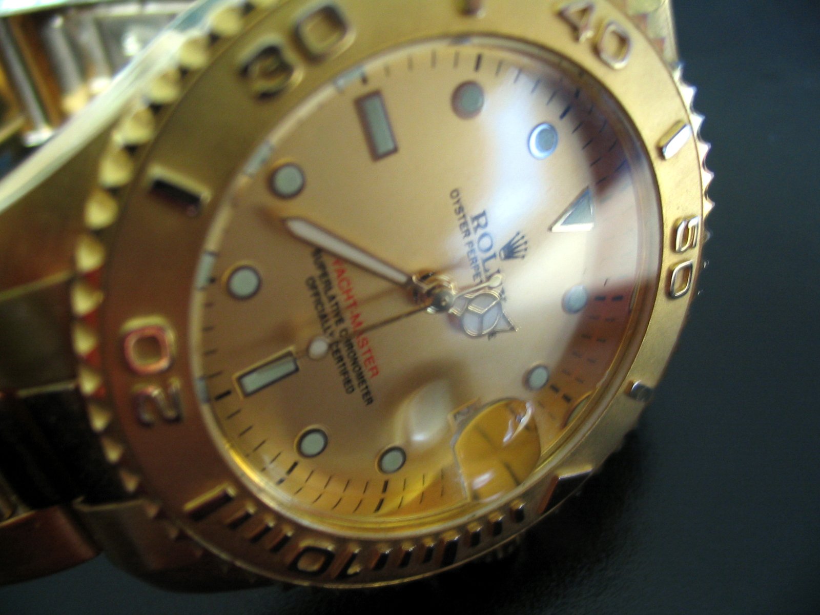 a rolex watch that is shiny gold