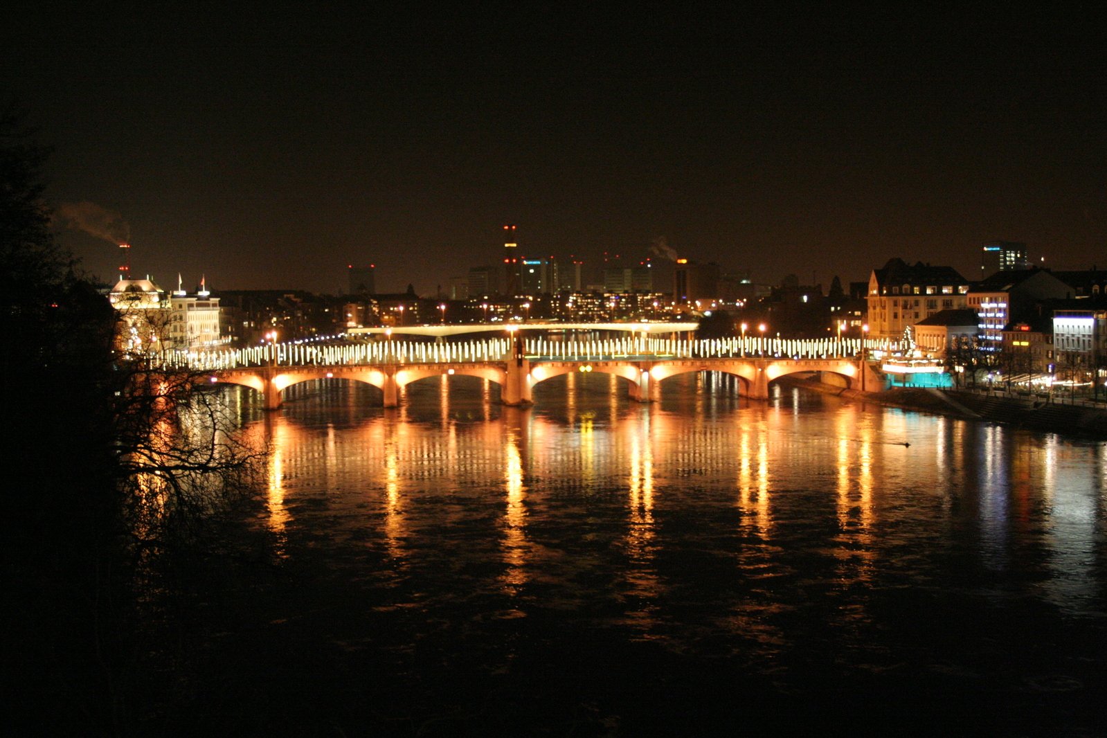 night view of lights on bridges in city and river