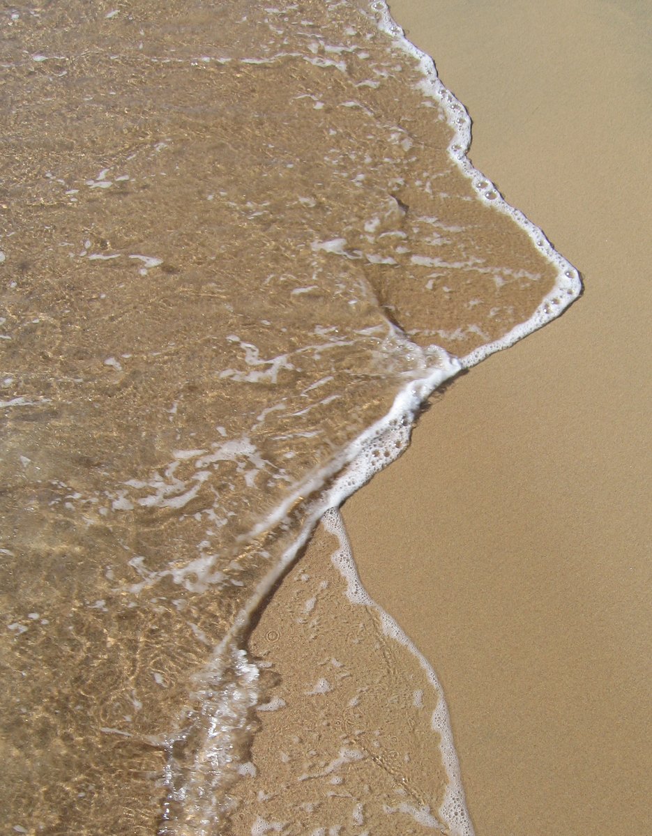 a closeup view of the beach and water
