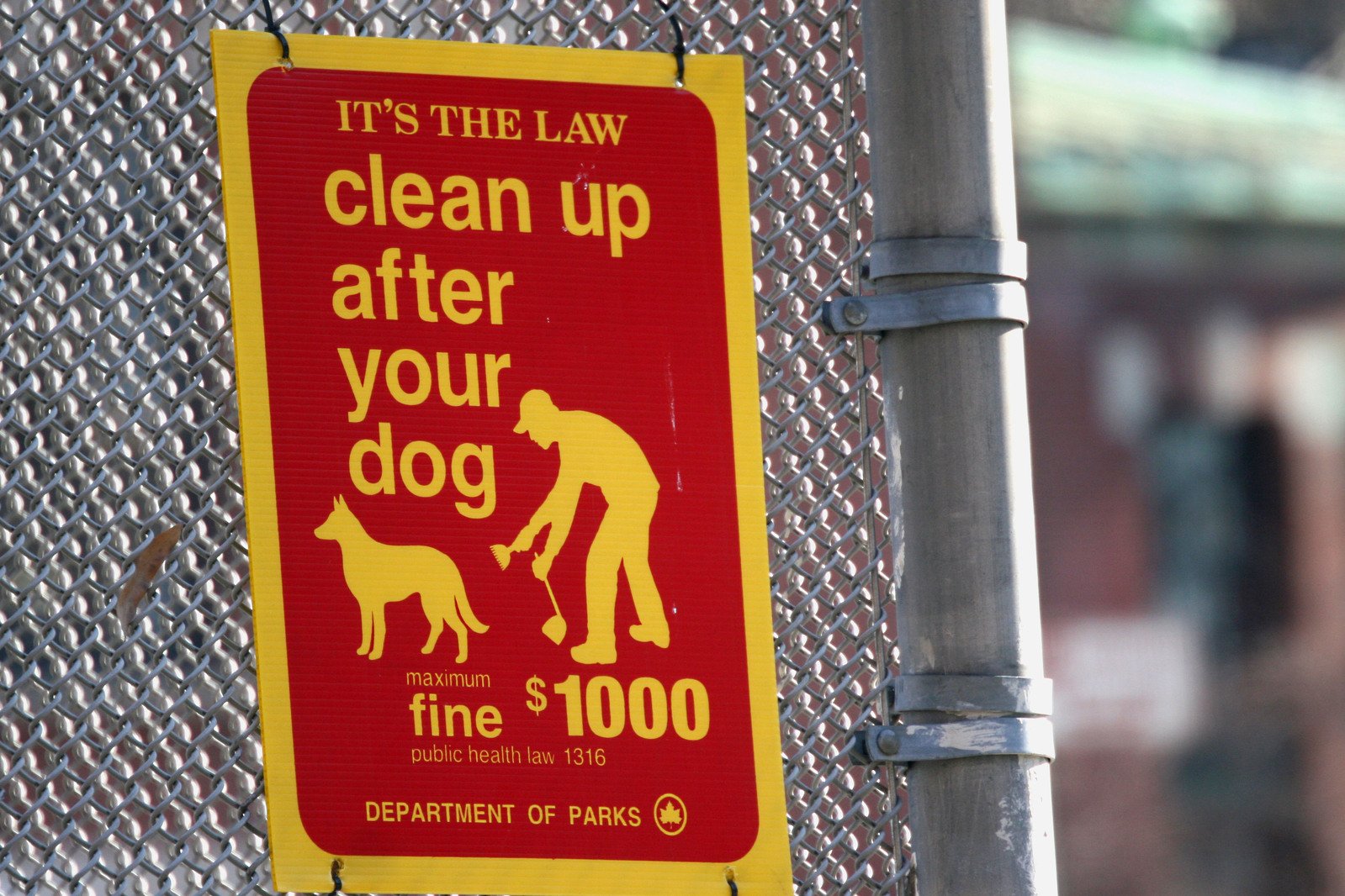 a sign in red on the side of a metal structure