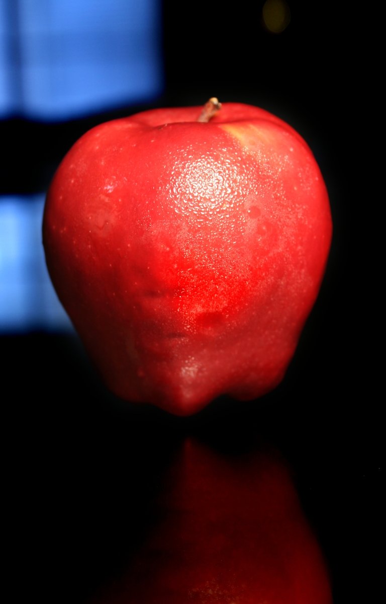 an apple sits on top of a counter