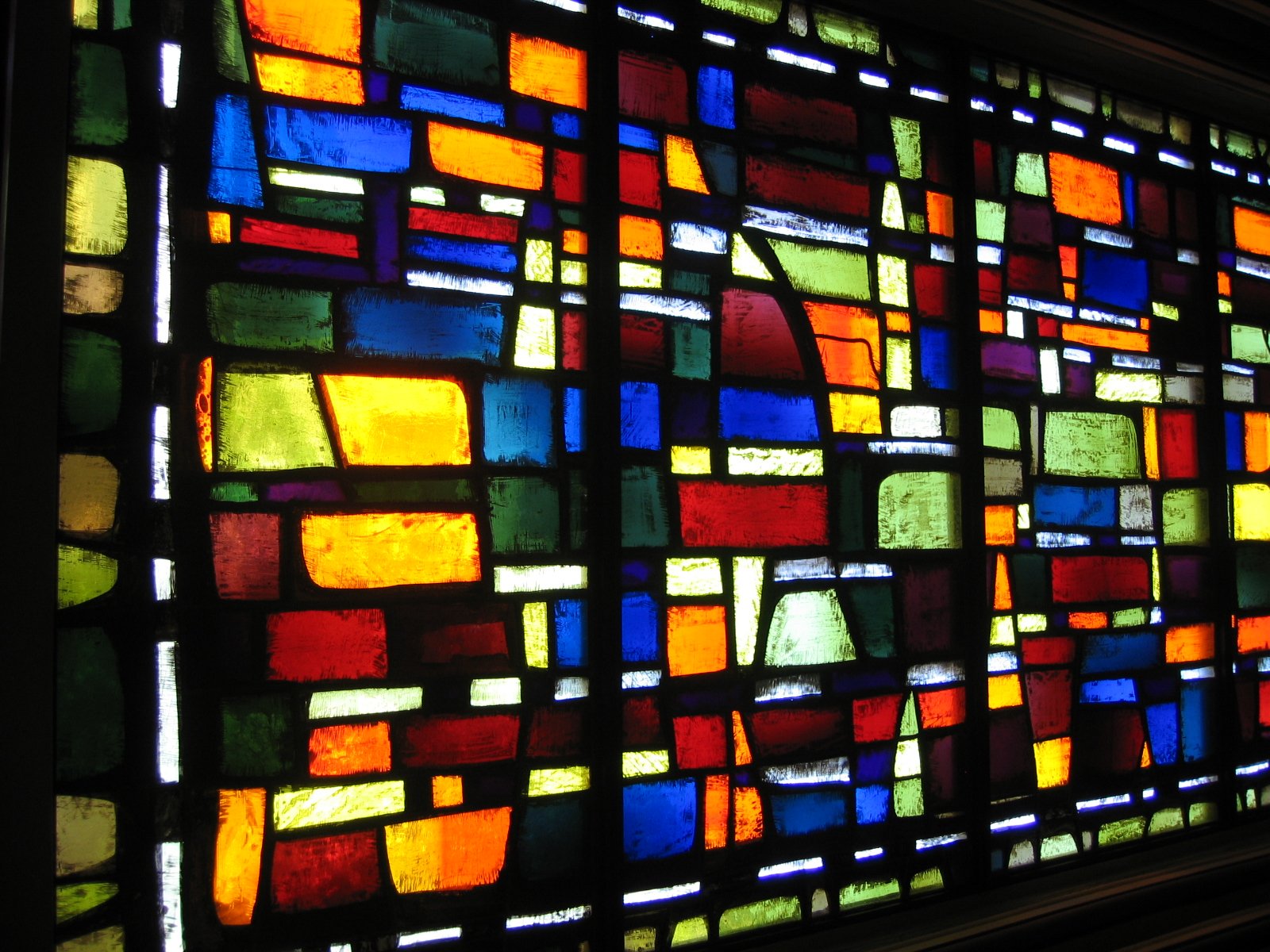 a large colorful stained glass window with squares on it