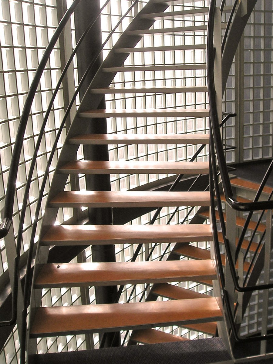 a metal staircase and stairs with wooden treads
