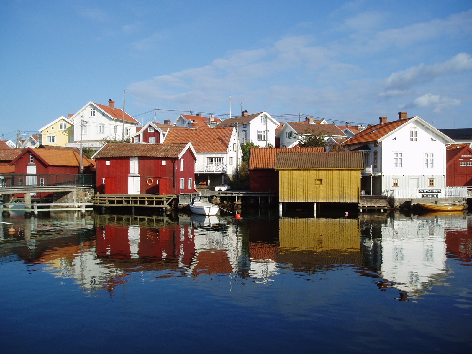 many small wooden houses are beside water