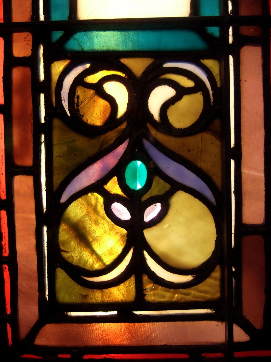a large colorful stained glass window on display