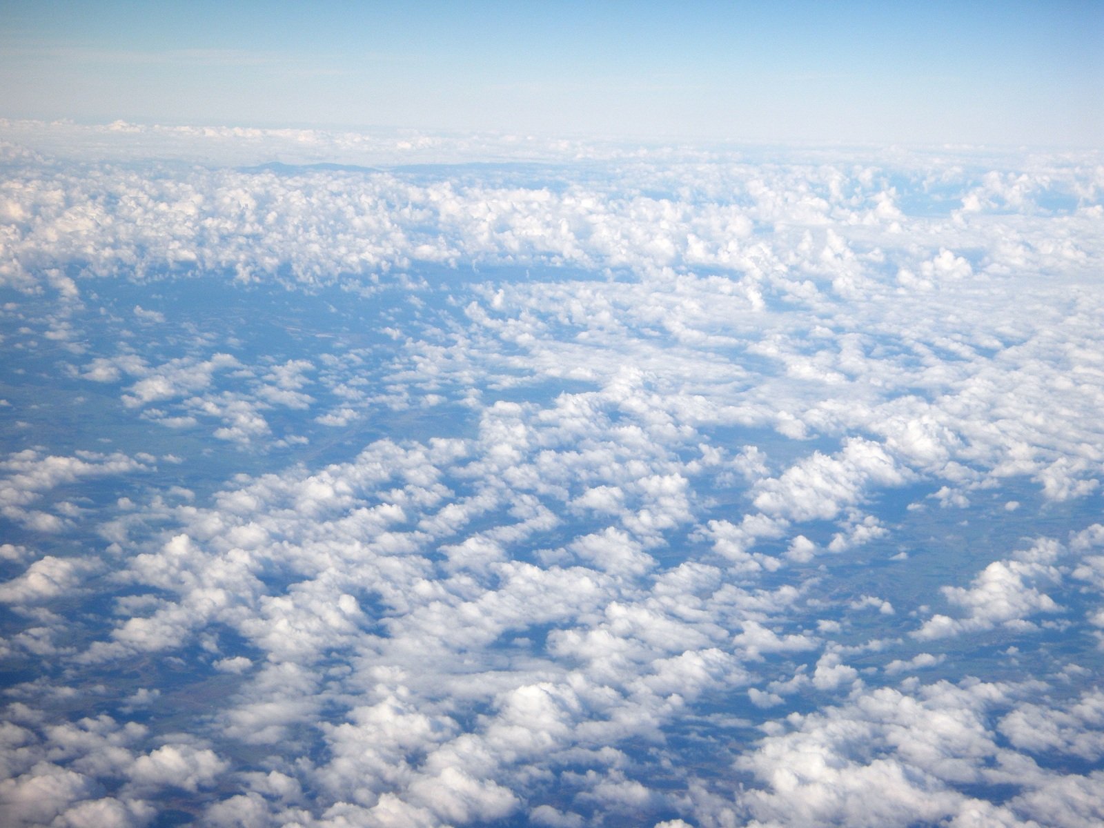 an aerial view of clouds and blue sky