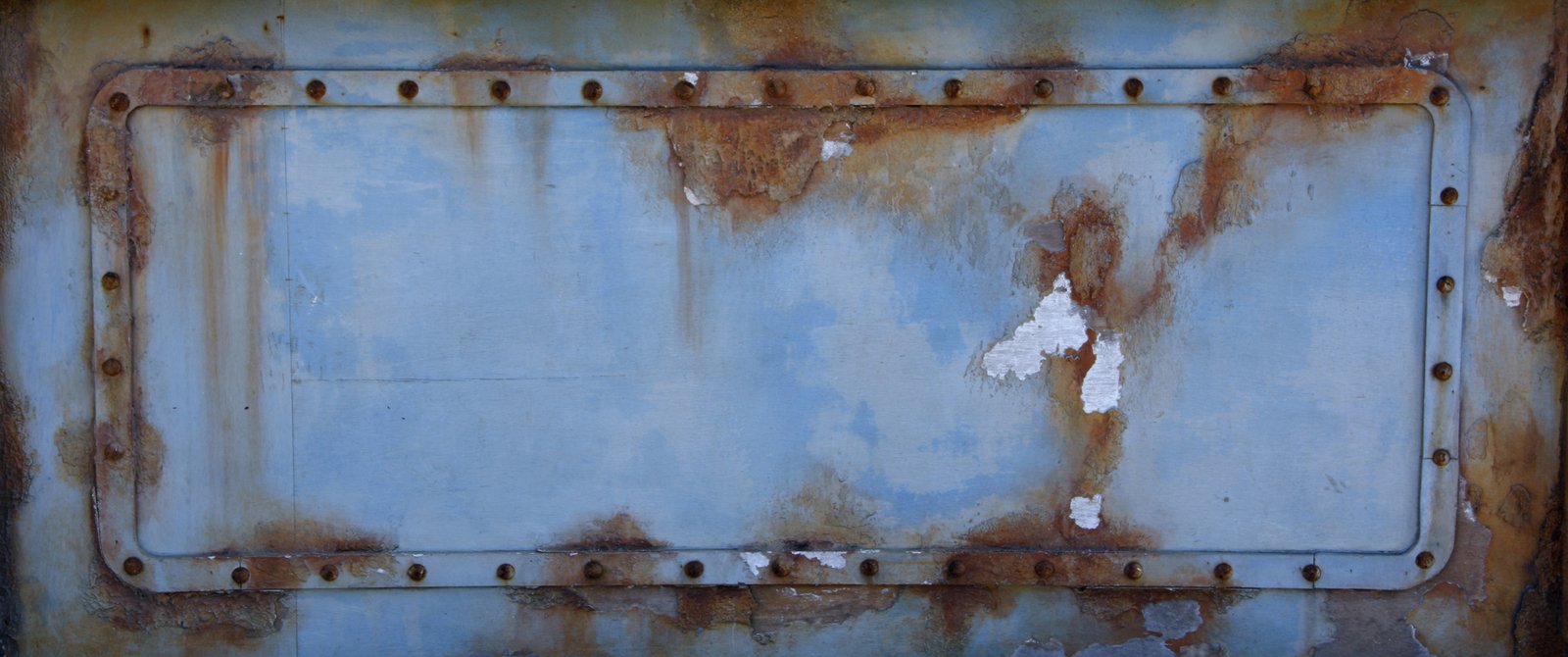 the rusted metal panel has lots of rust on it