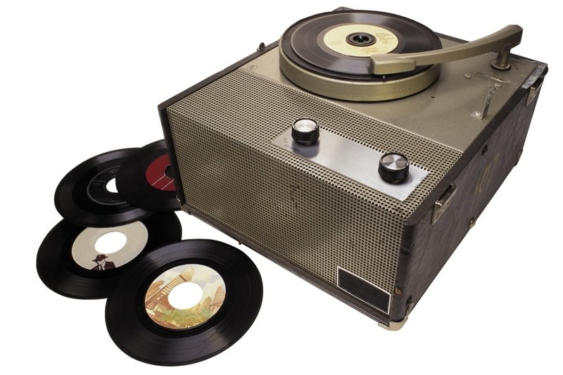 a record player with two black wheels next to it