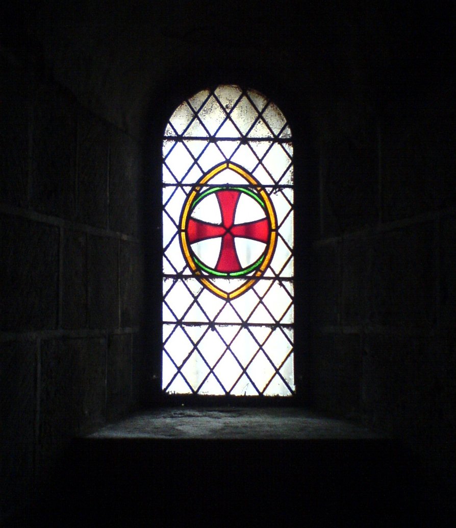 an old stained glass window in a dark room