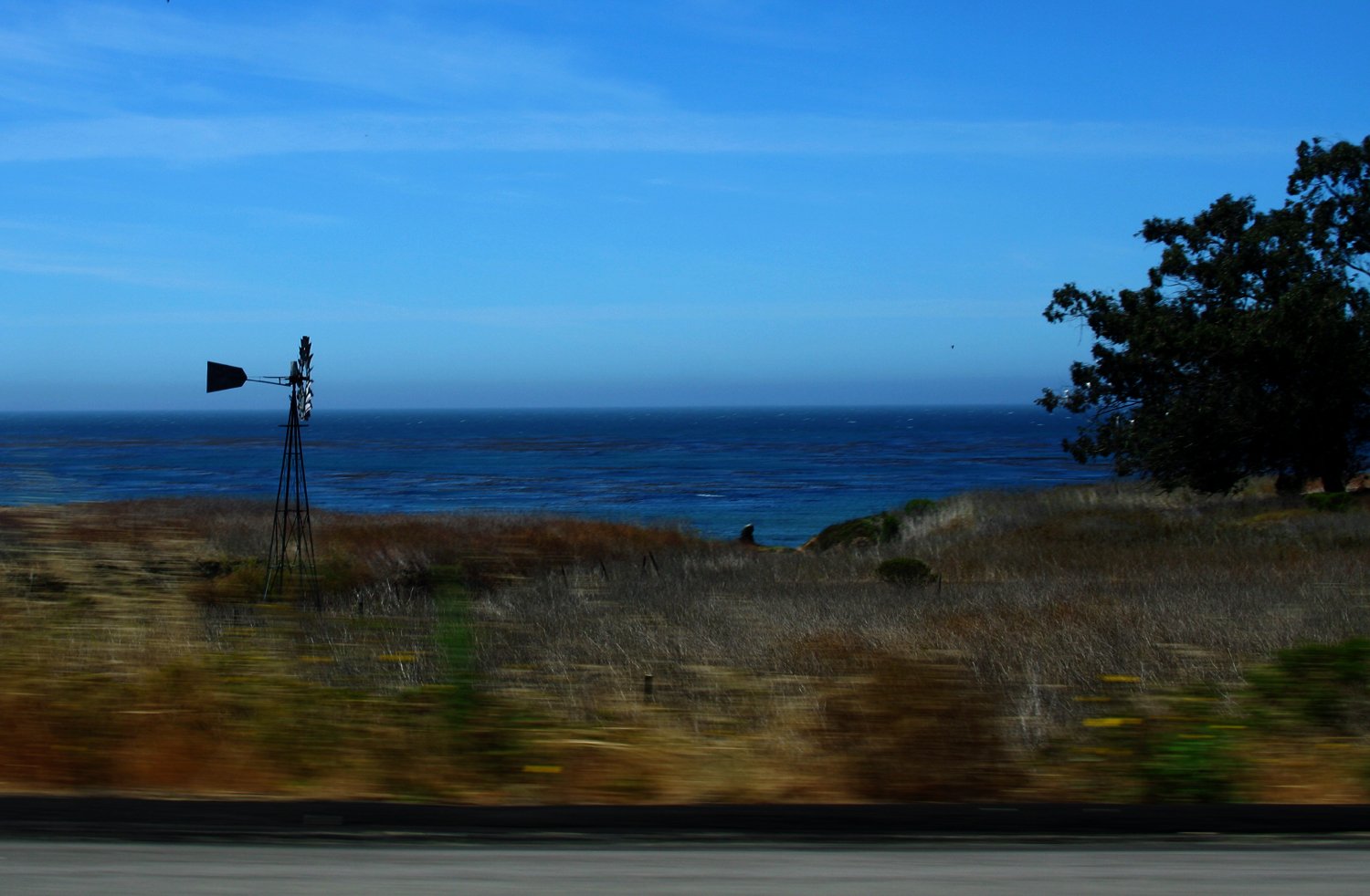 a hill sitting next to the ocean on a sunny day