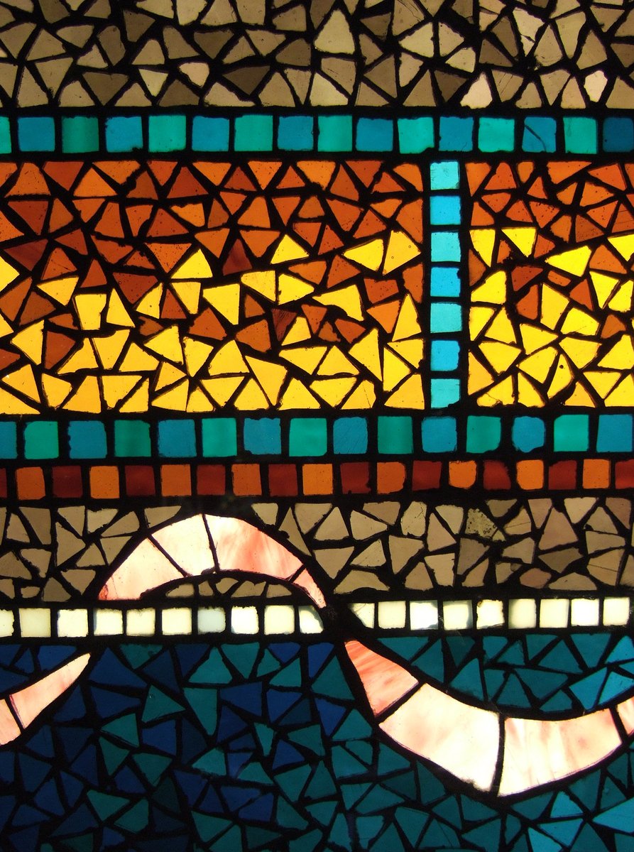 a close up of an artistic stained glass window