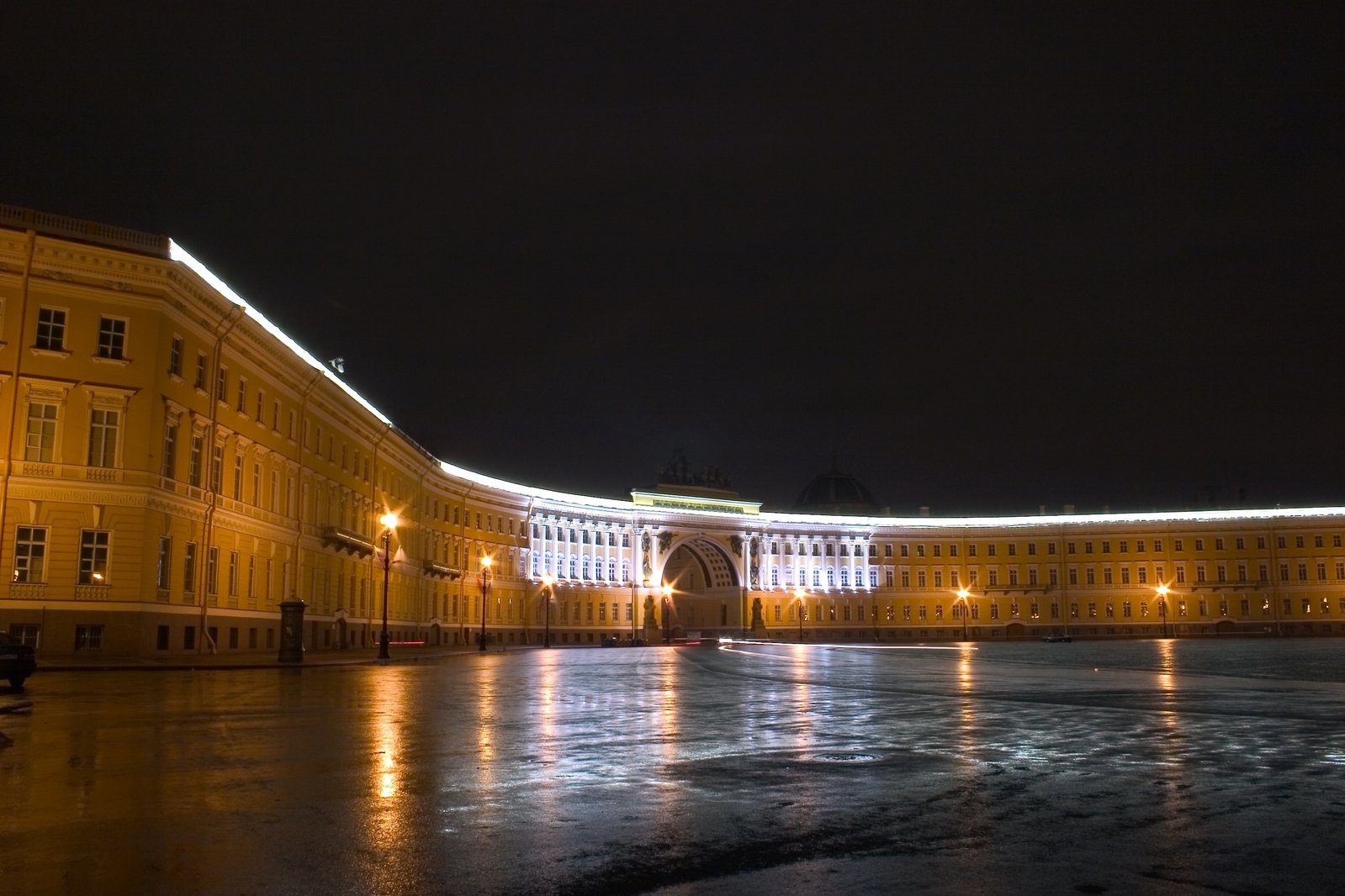 a snowy square is lit up with holiday lights