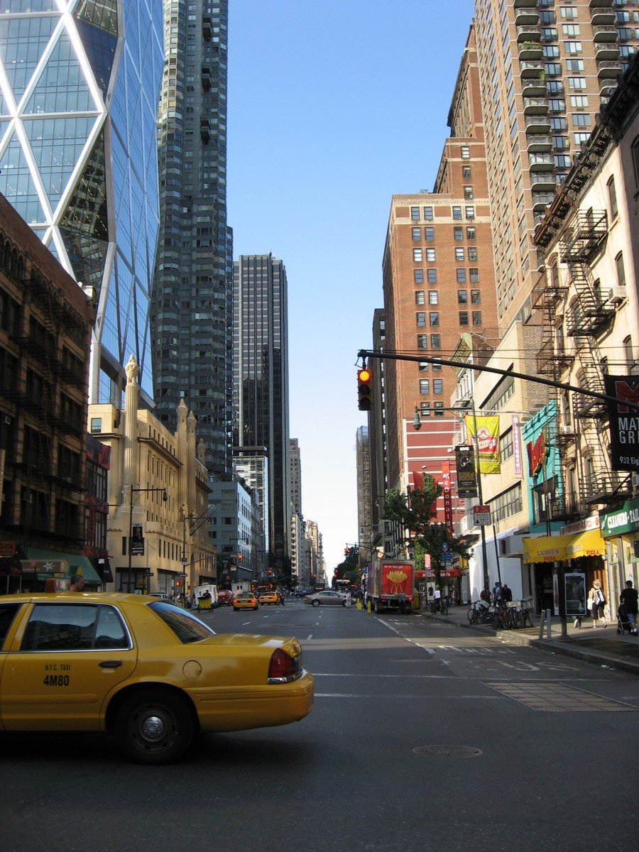 a taxi cab is seen moving down a city street