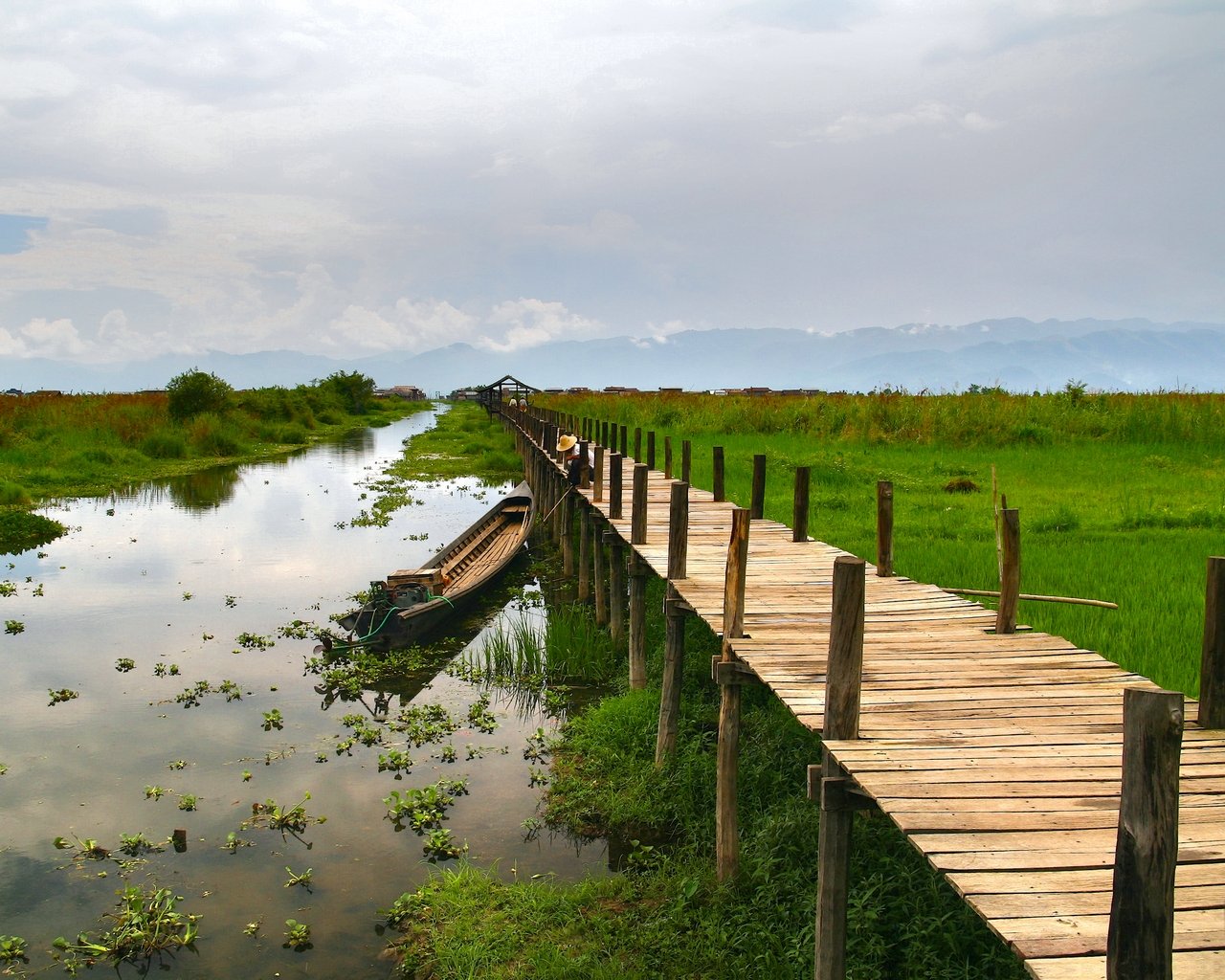 a small long dock with a boat on it