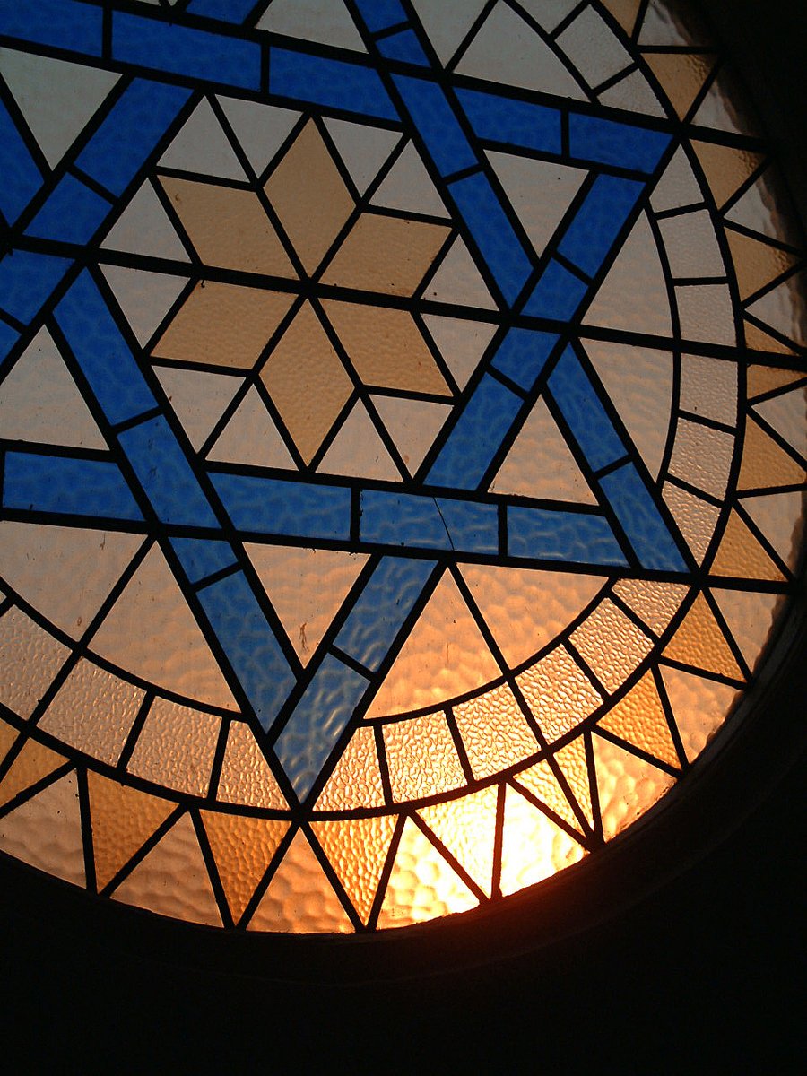 stained glass in a round window with blue triangles