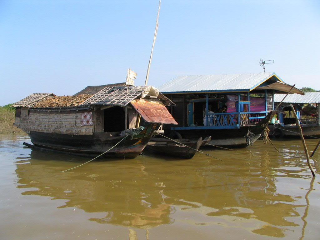a wooden houseboat is out in the water