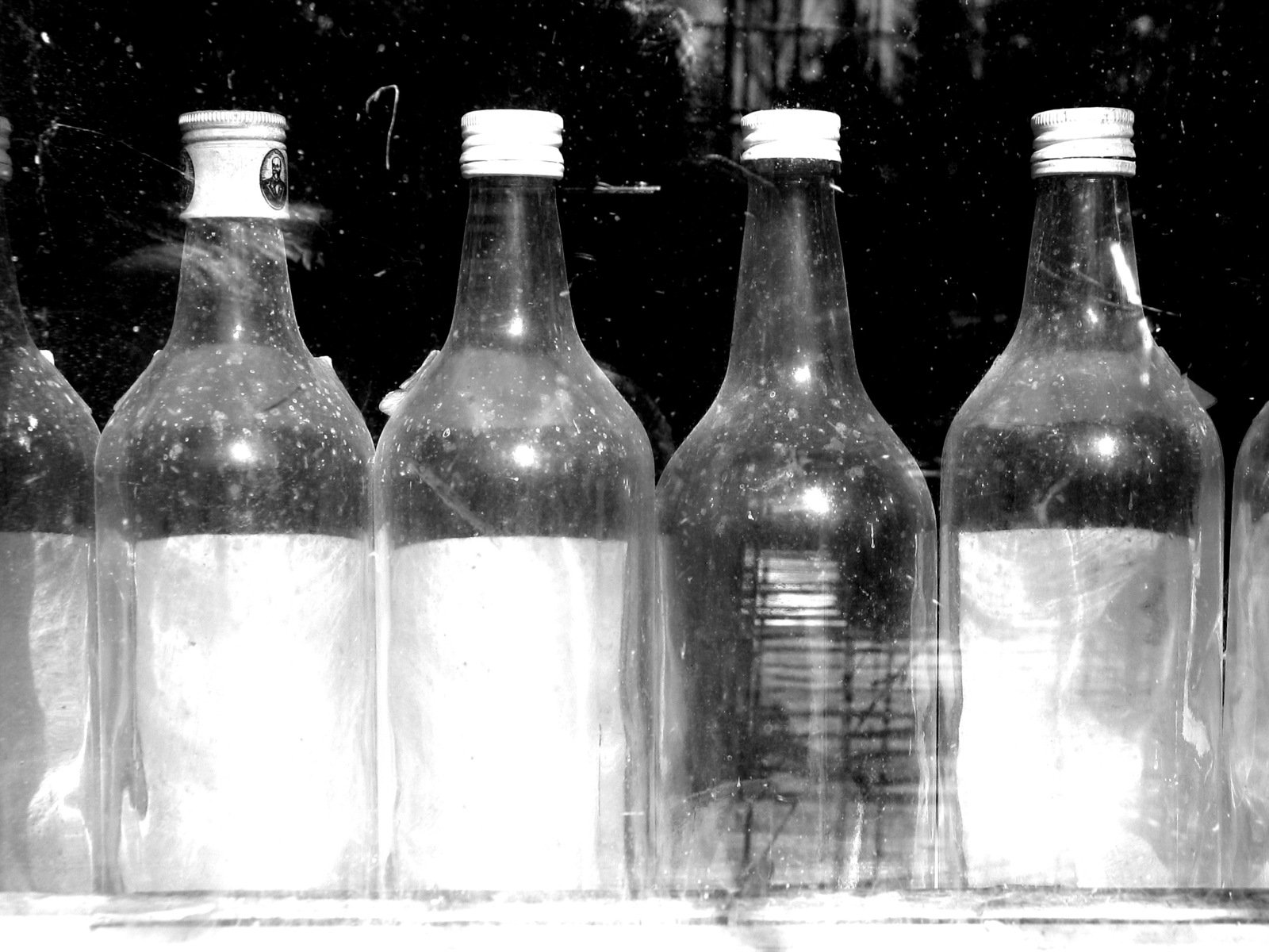 a row of bottles sitting on top of a window