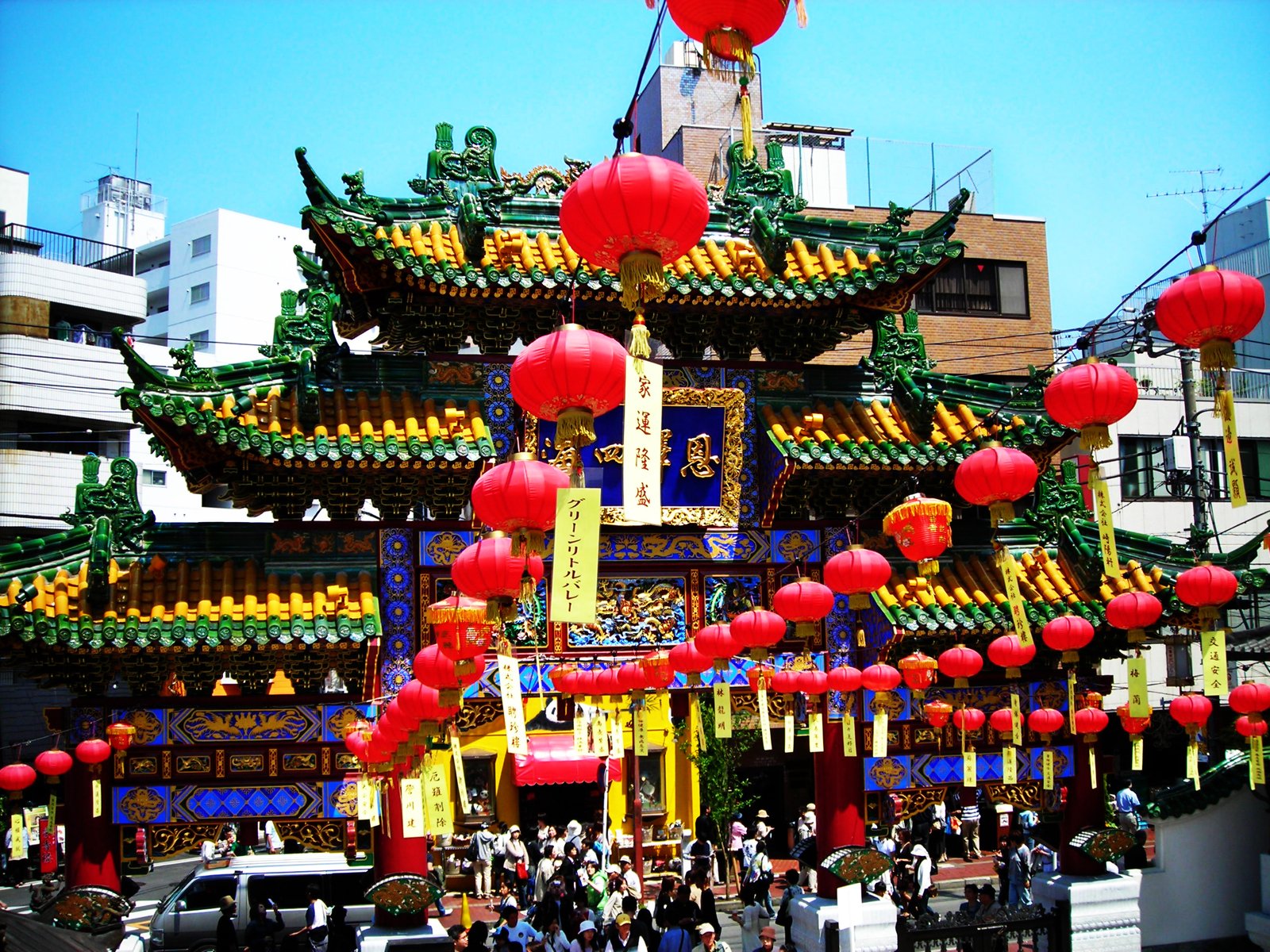 people standing outside of a brightly colored building