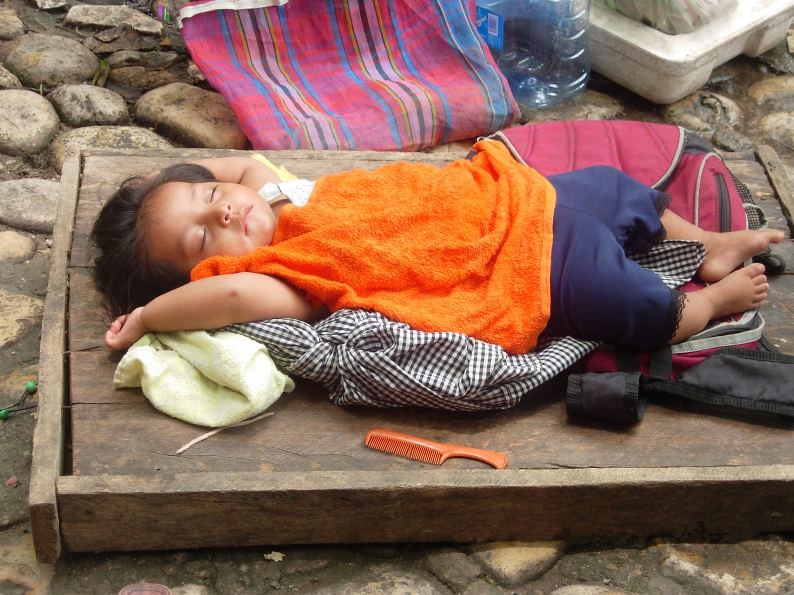 a little child is laying on some rocks