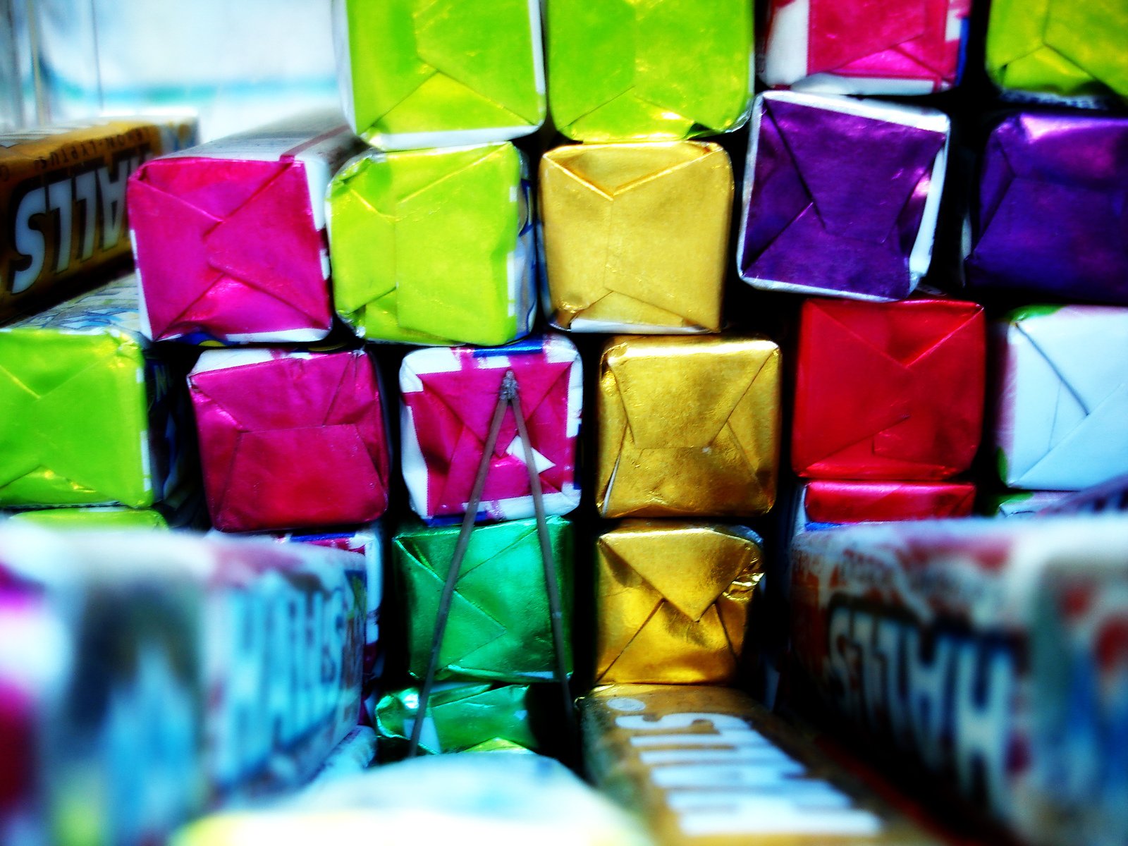 the large, multi - colored boxes were wrapped in tissue paper