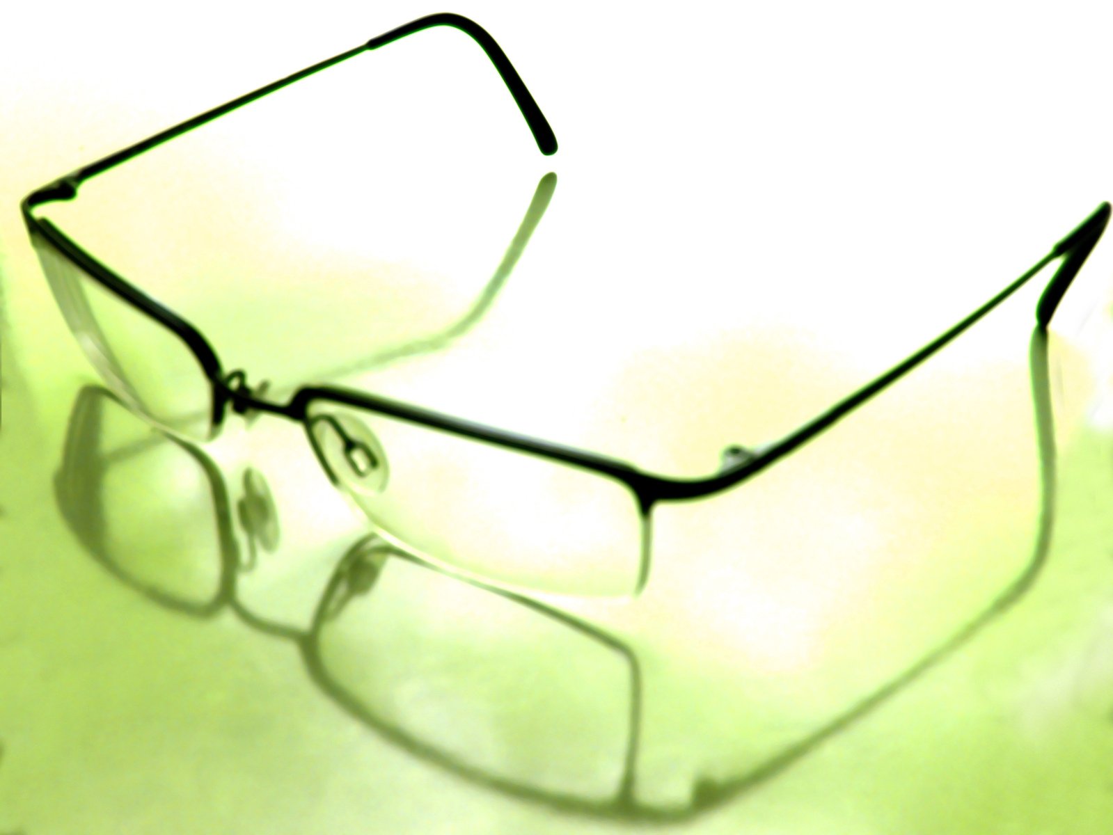 a pair of glasses with different rims on a white surface