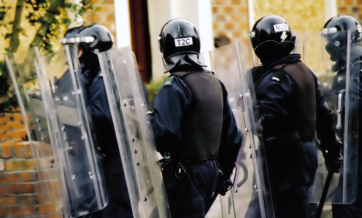 some cops standing with their guns in a line