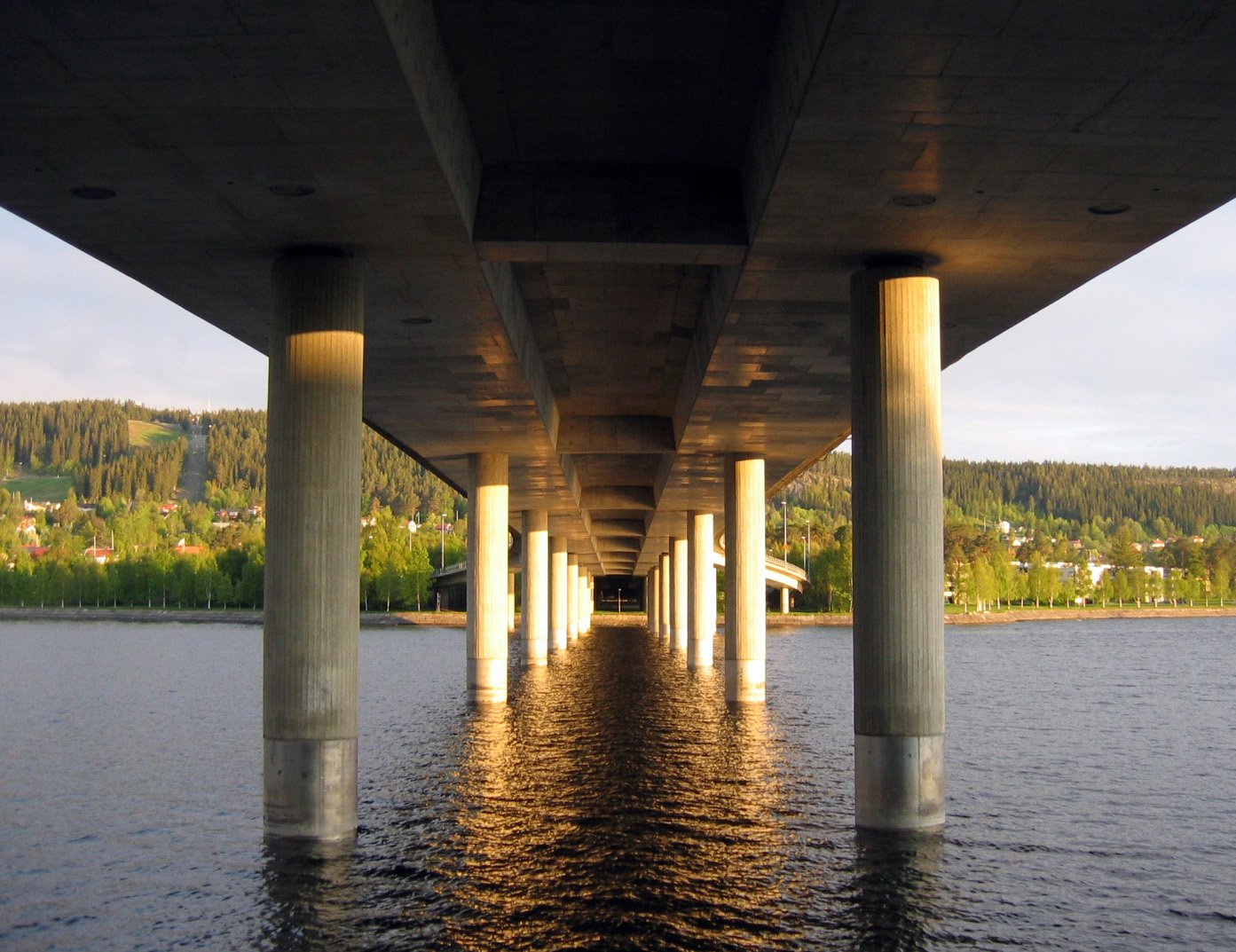 an image of the inside of a long bridge in the water