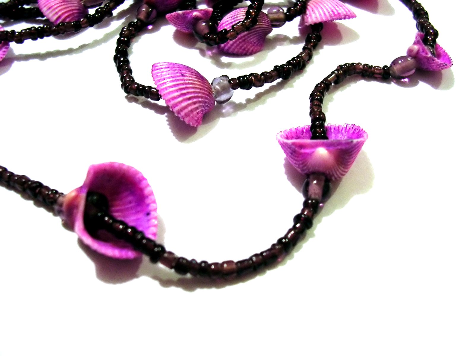 a purple necklace with purple flowers hanging down