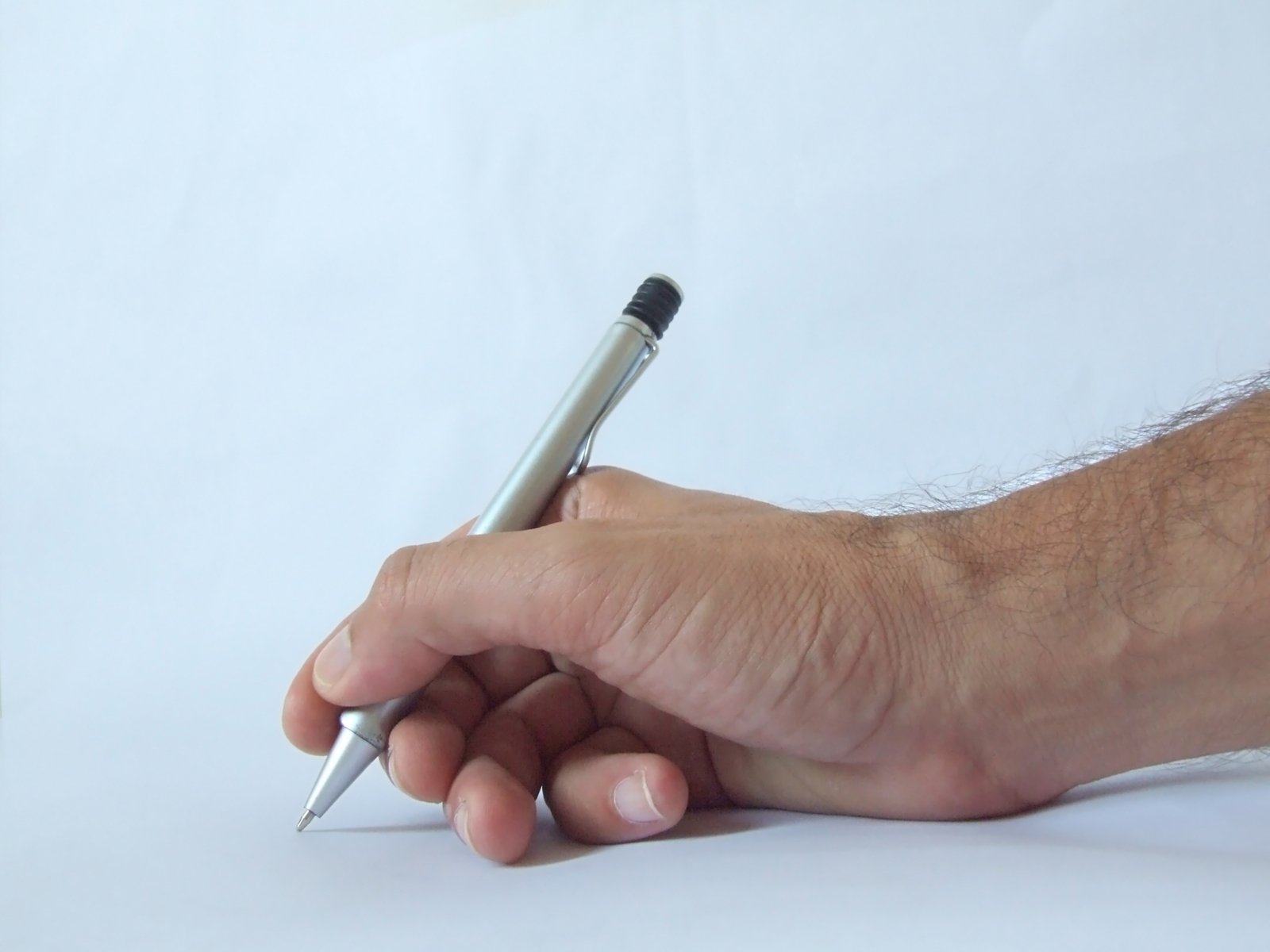 someone holding their finger near a tiny pen