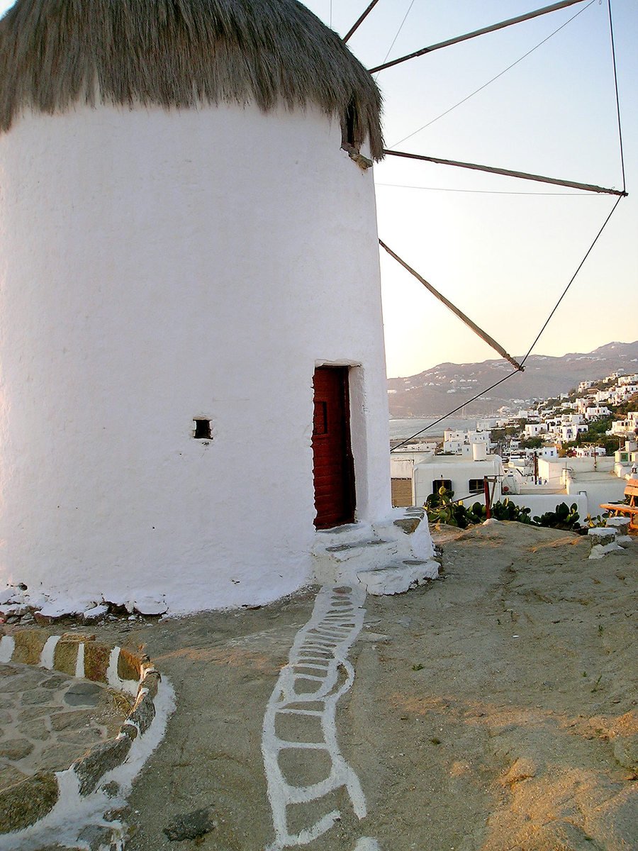 the small white building has a red door