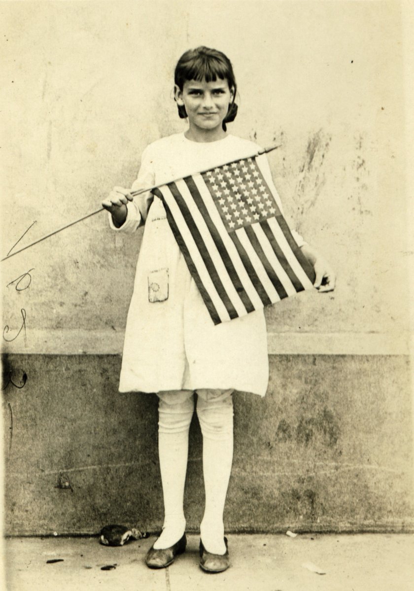 a  with a large american flag is holding a flag