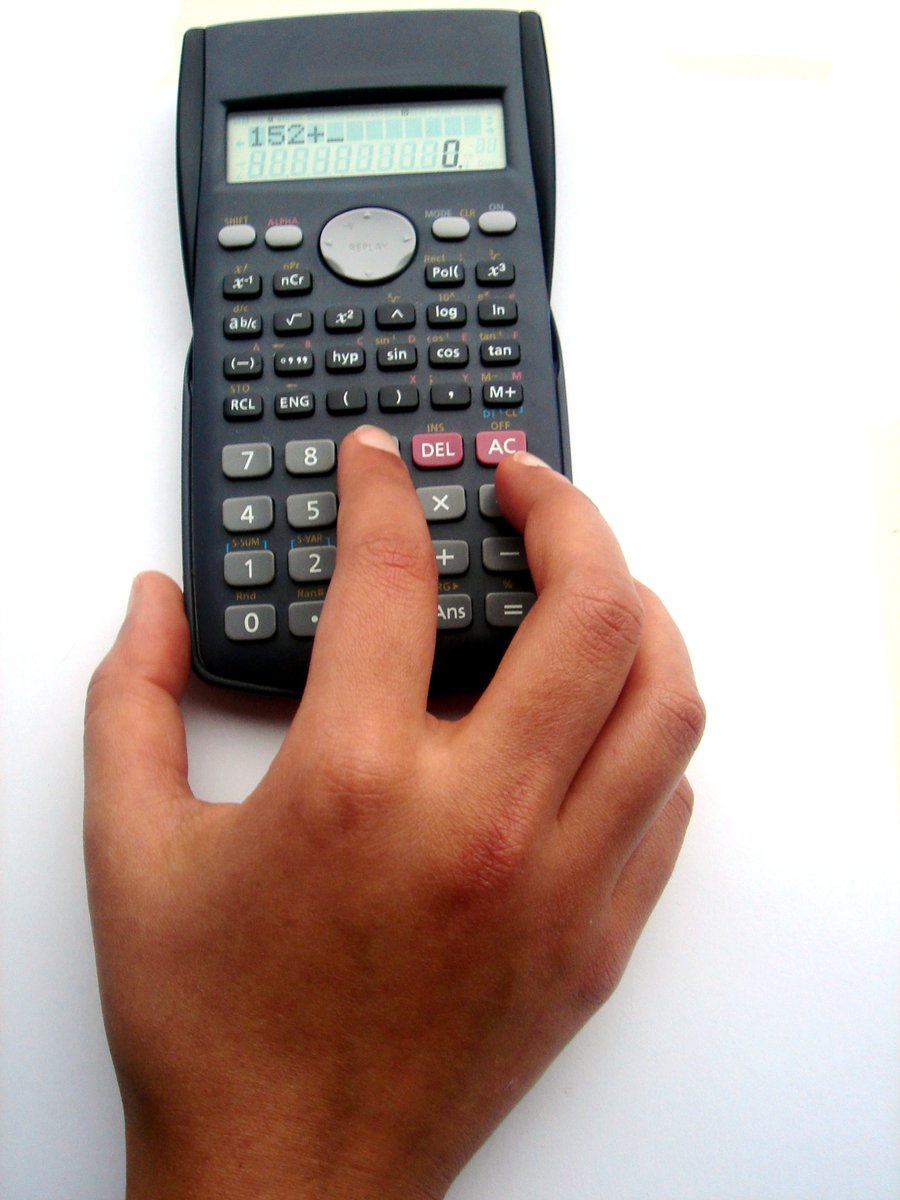a hand is using the calculator to check the time