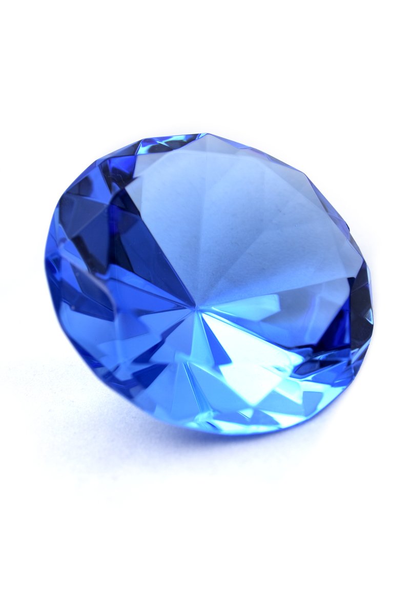 a very pretty blue crystal stone on a white background