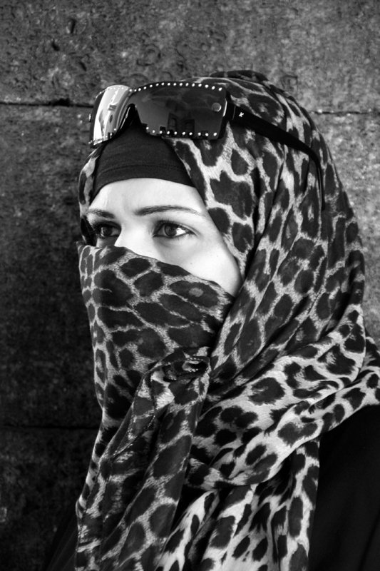 a woman wearing a scarf over her face