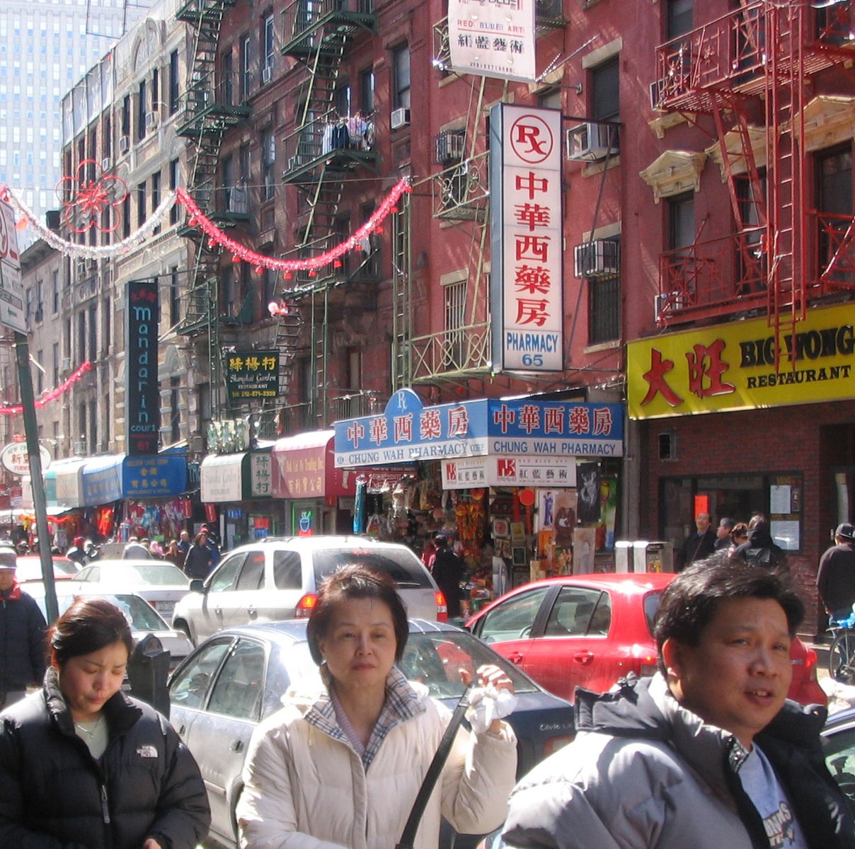 pedestrians in an asian city walk down the street
