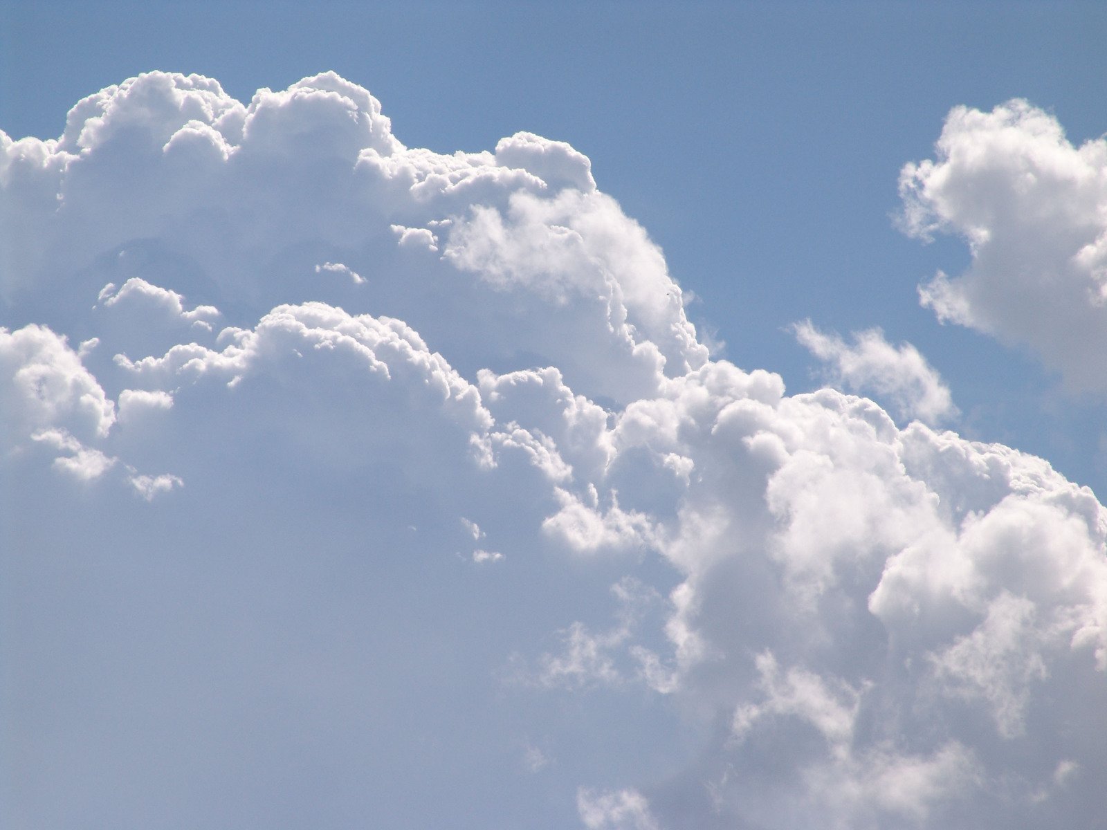 clouds are floating in the air and blue sky