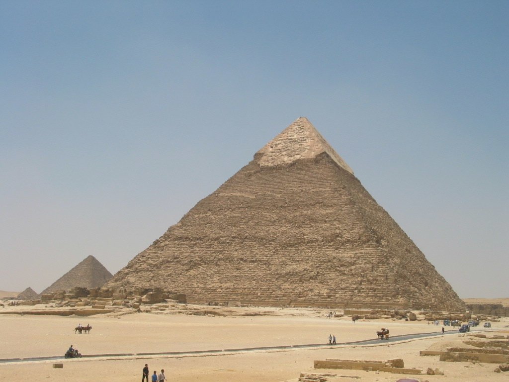 several people standing outside near the pyramids