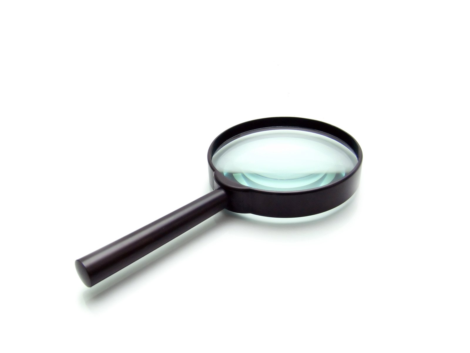 a magnifying glass on top of a white surface