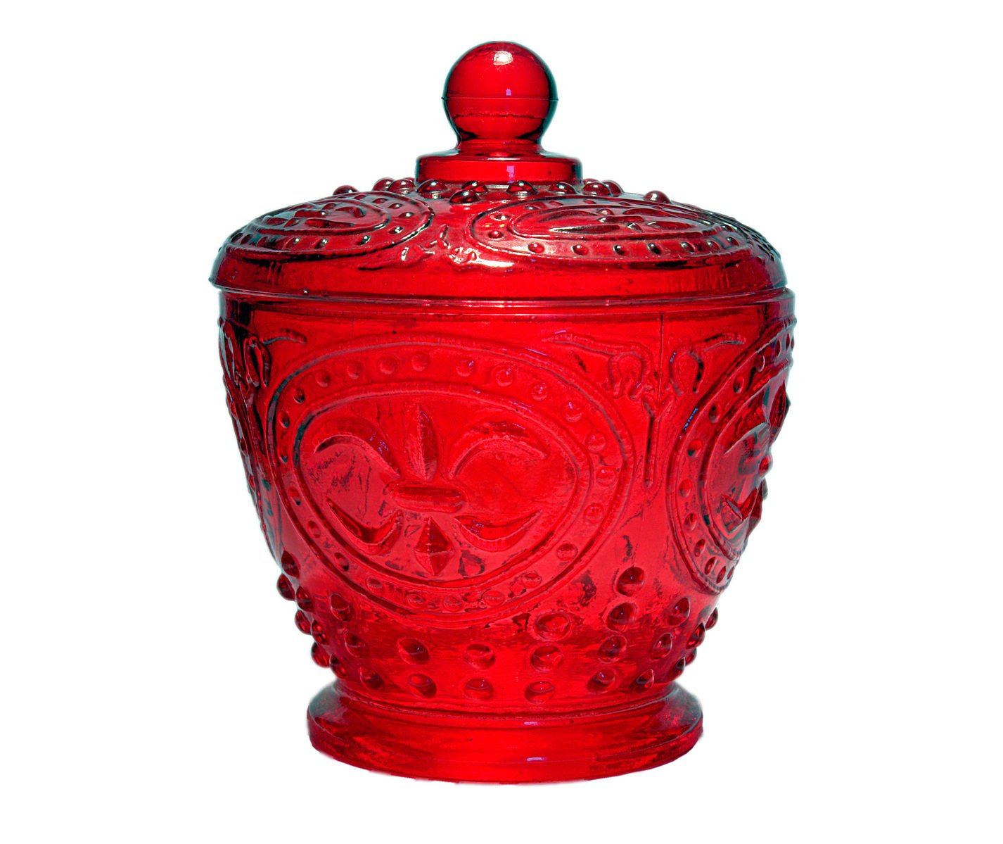 an ornate red glass jar with a lid on a white background