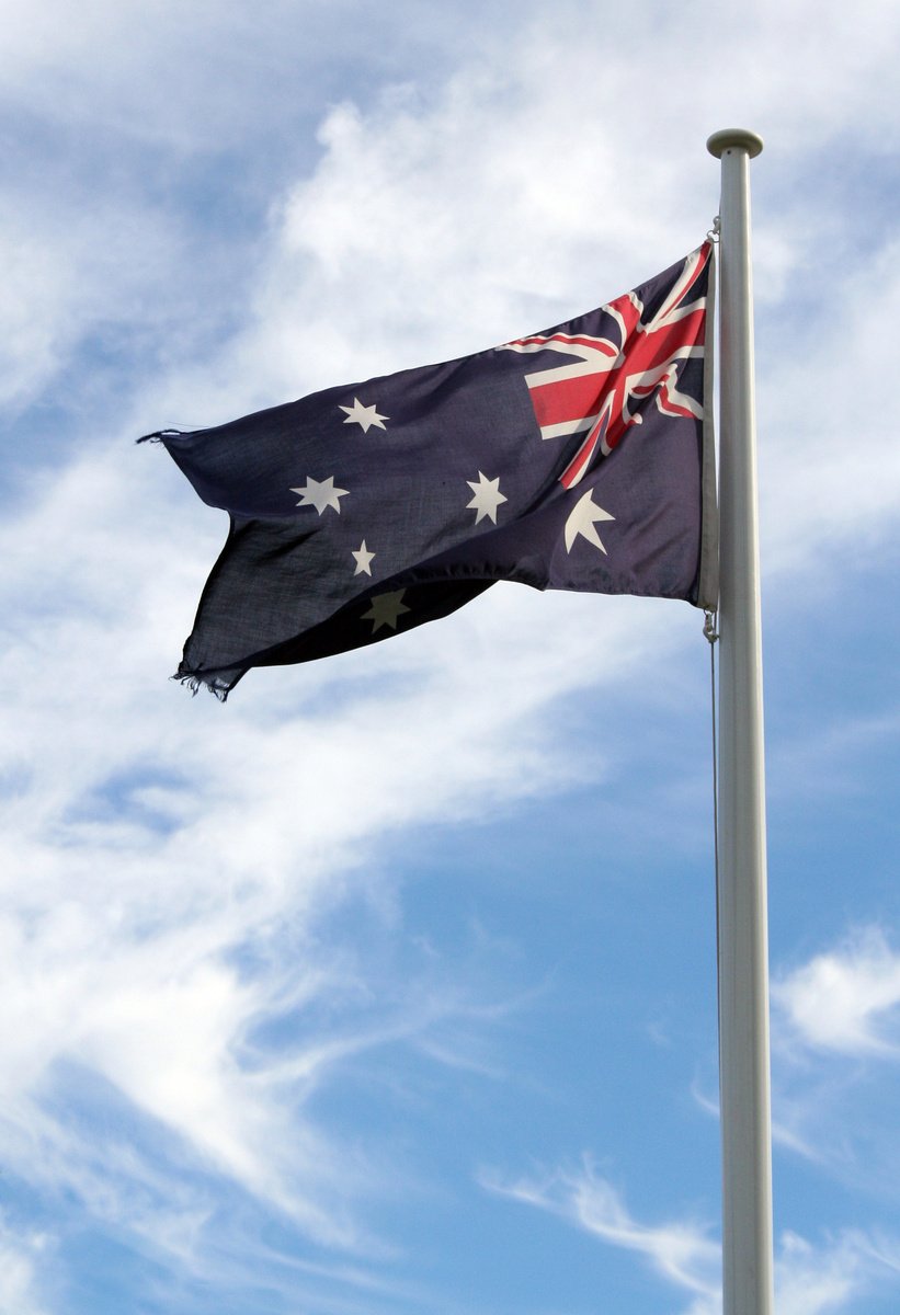 an australian flag flying high in the sky